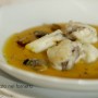 Rana pescatrice in crema di zucca con vongole patate affumicate e sale al limone