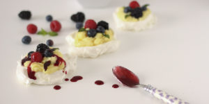Mini pavlove con crema pasticcera, coulis e frutti di bosco